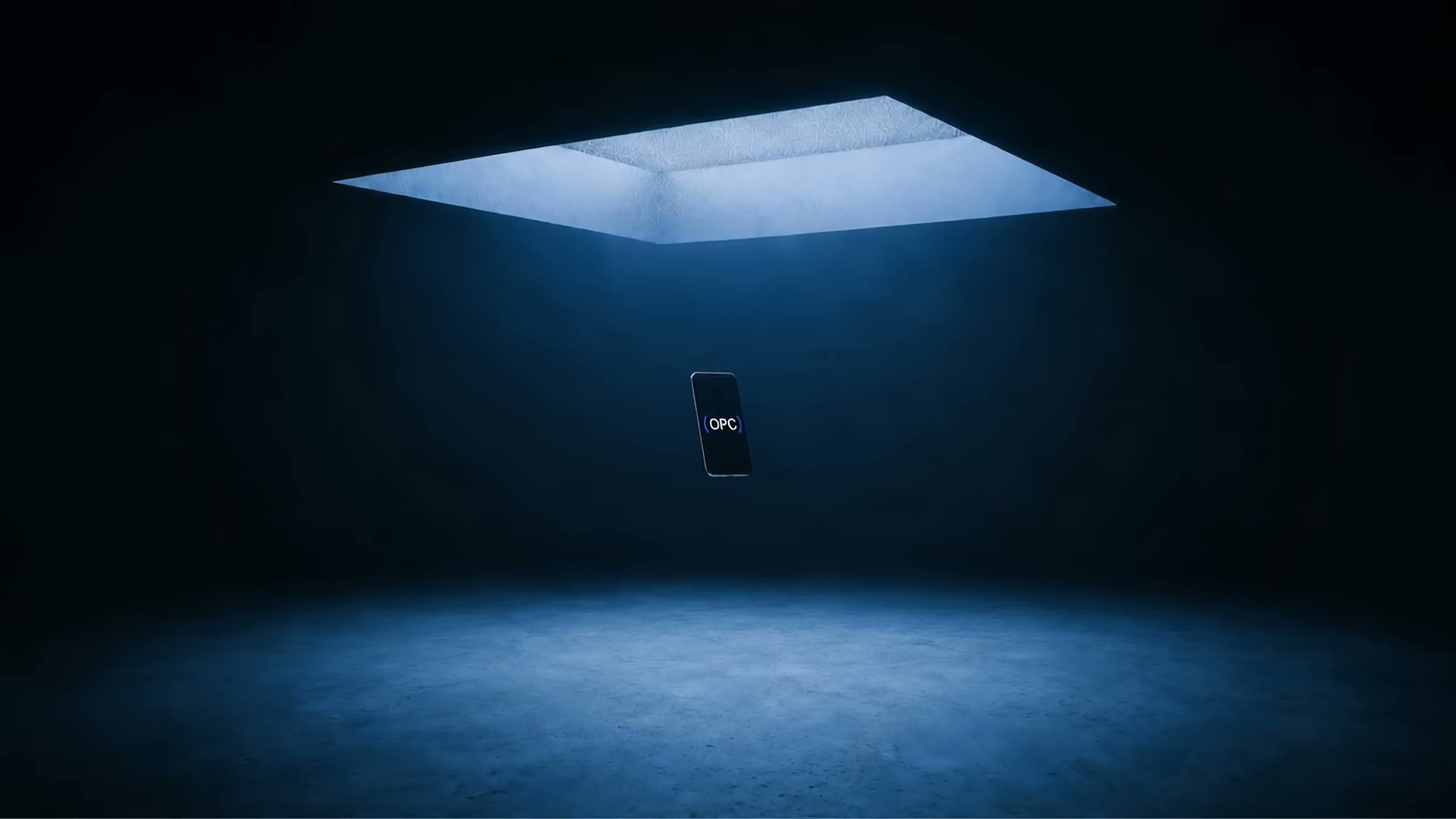 A handset turning in a dark room under a skylight, the ( OPC ) mark lit on its screen.