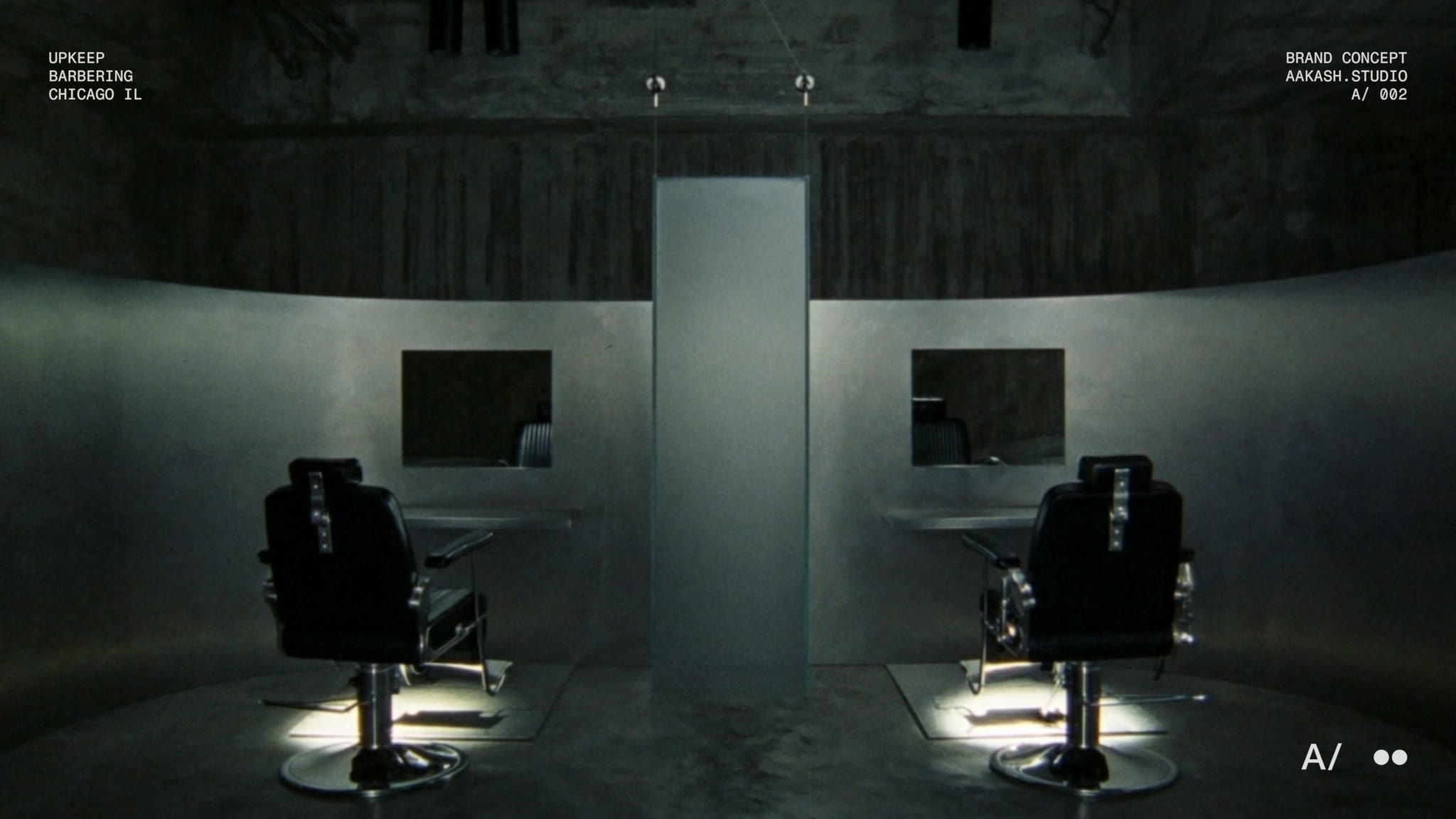 The UPKEEP room: two black barber chairs either side of a frosted divider, each lit from below