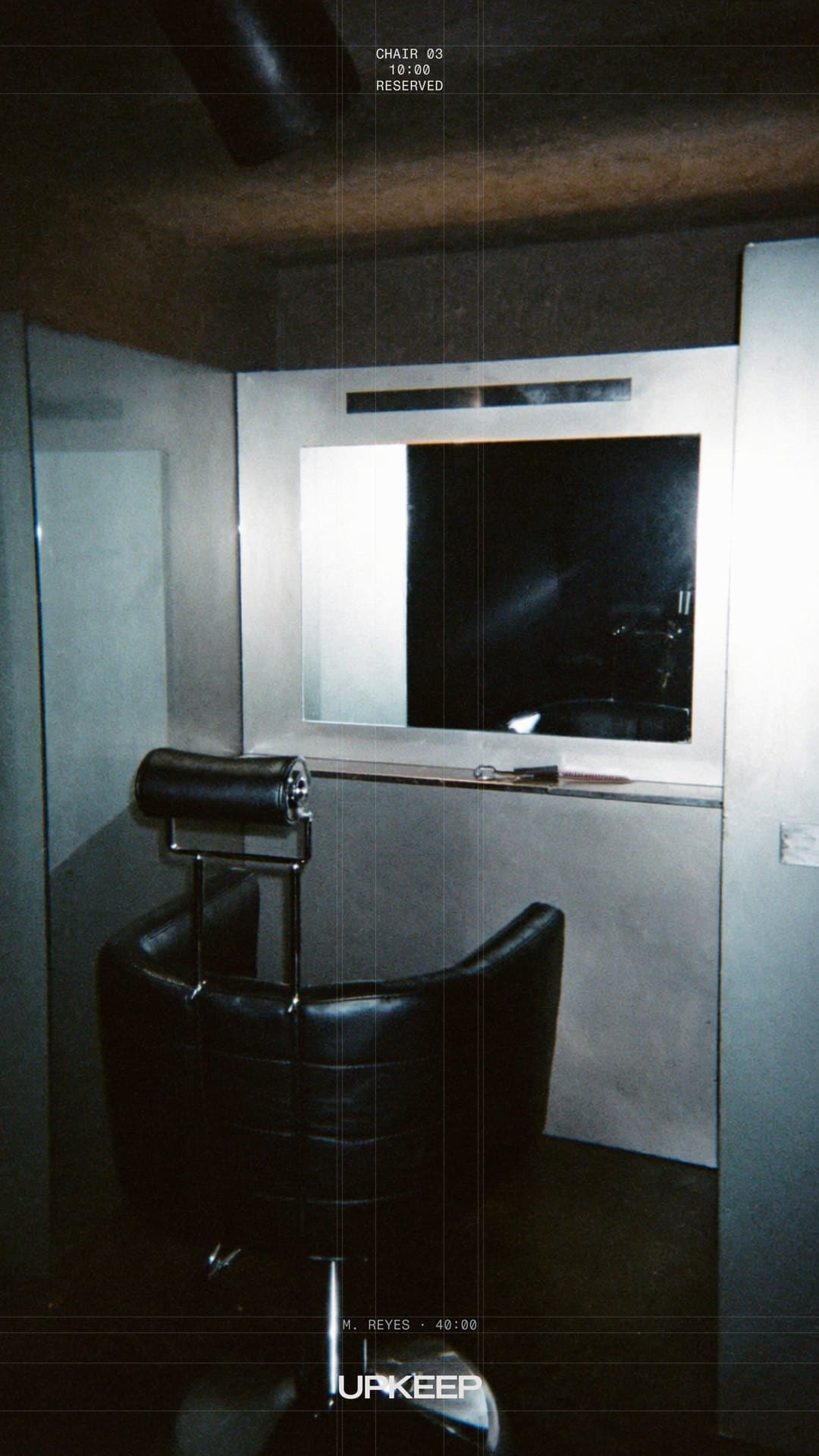 Story: a chair in front of a lit mirror, marked CHAIR 03, RESERVED.